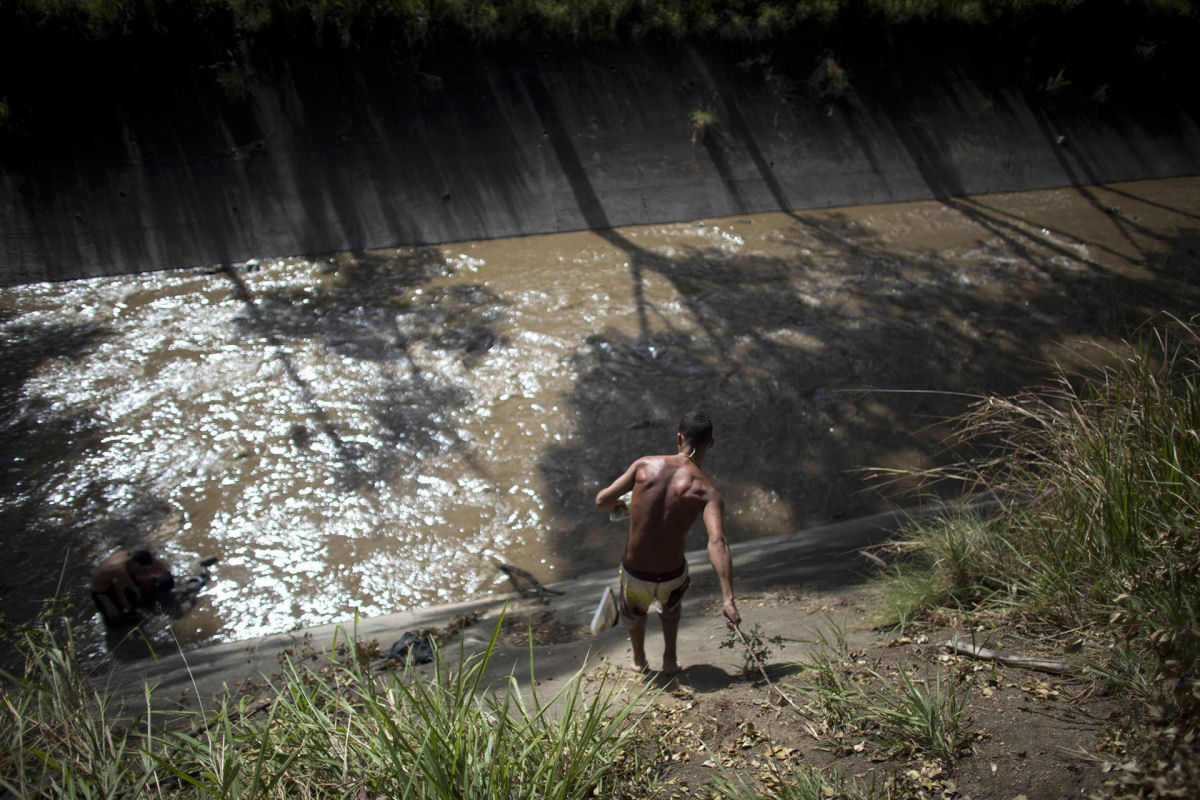 O drama dos jovens venezuelanos que garimpam sucata em um rio poludo para revend-la e poder comer 08