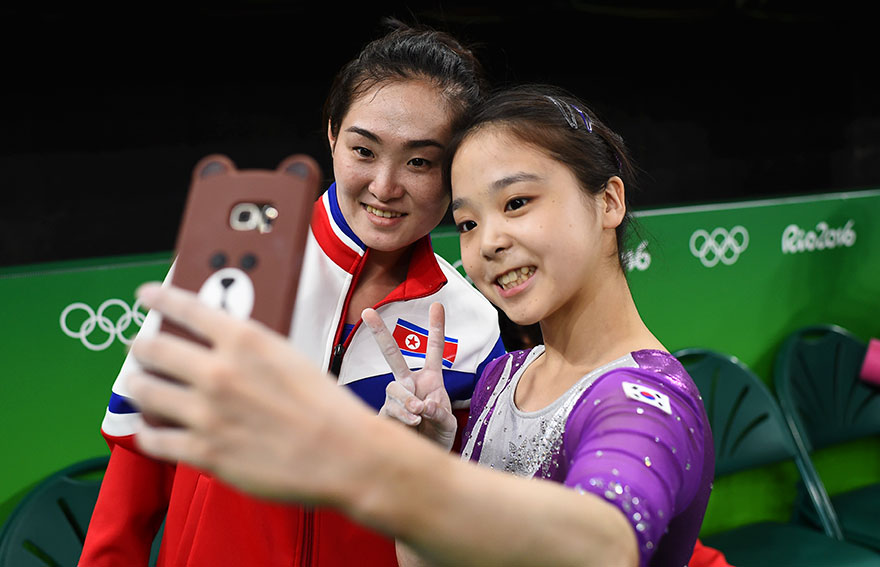 Ginastas olmpicas da Coreia do Sul e do Norte fazem uma selfie juntas.