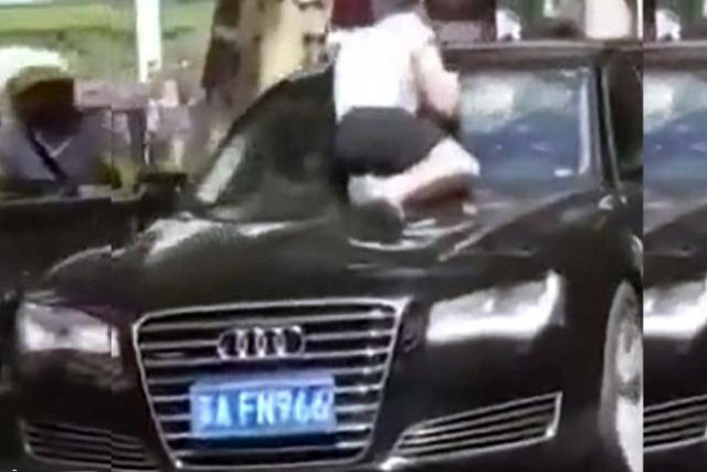 Chinesa sobe no cap de um carro em movimento para enfrentar seu marido infiel e a amante