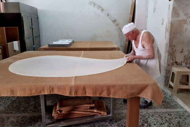 O padeiro grego, de 86 anos, e sua família, que continuam a tradição de fazer massa folhada à mão