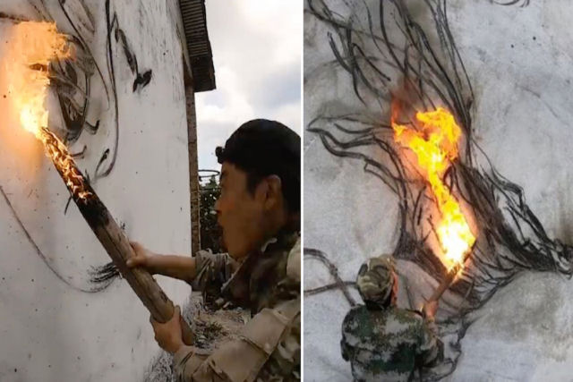 Artista desenha murais com o carvão de um pau flamejante